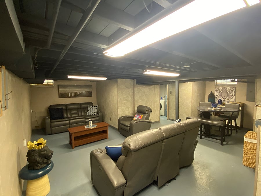 Finished basement with 2 leather sofas that have two electronic recliners each