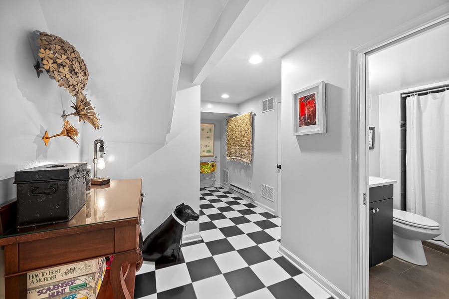 Hallway with antique table filled with games.