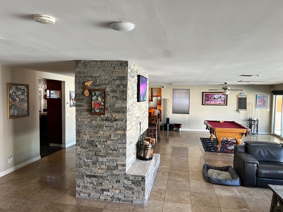 Large shared open space. With living room, couch and 50" TV. Dining room and a pool table.