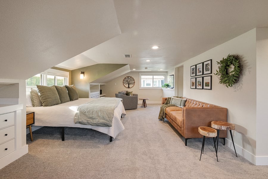 Elevate your stay in the top-floor Durant Suite, featuring a king bed, cozy couch, TV sitting area, study space, walk-in closet, two built-in dressers, and private full bathperfect for comfort, style, and relaxation.
