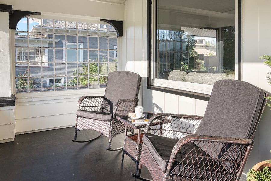 Savor a peaceful sunrise over Bush Park while enjoying your morning coffee in one of the four rocking chairs on the porch. A perfect way to start your day in tranquil comfort.