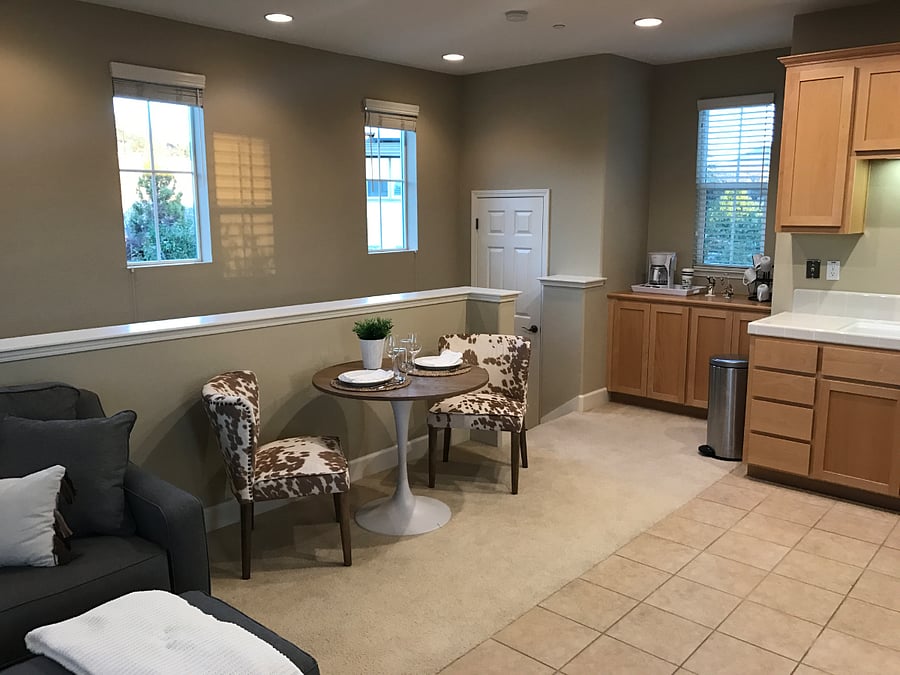 View looking back towards entry stairs. There is a coat closet and a coffee bar area.