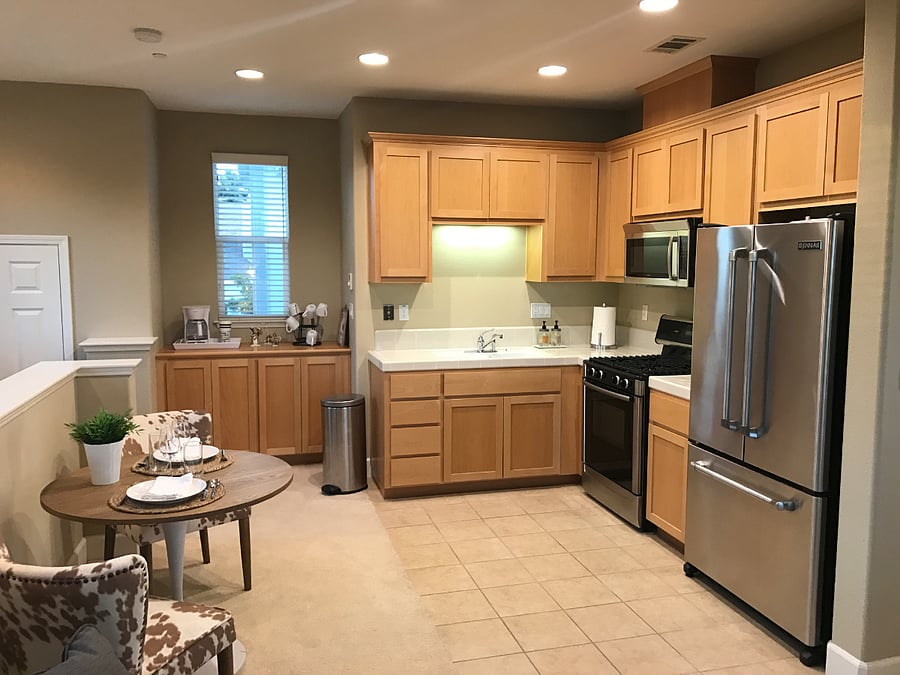 Full kitchen including a sink with disposal, range, microwave hood, and full-size refrigerator. 