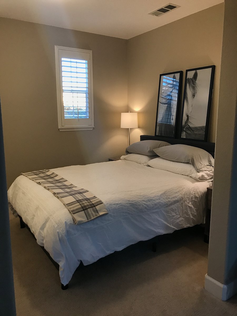 The bedroom is separated from the living area, but does not have a door, allowing the spaces to feel open but delineated.