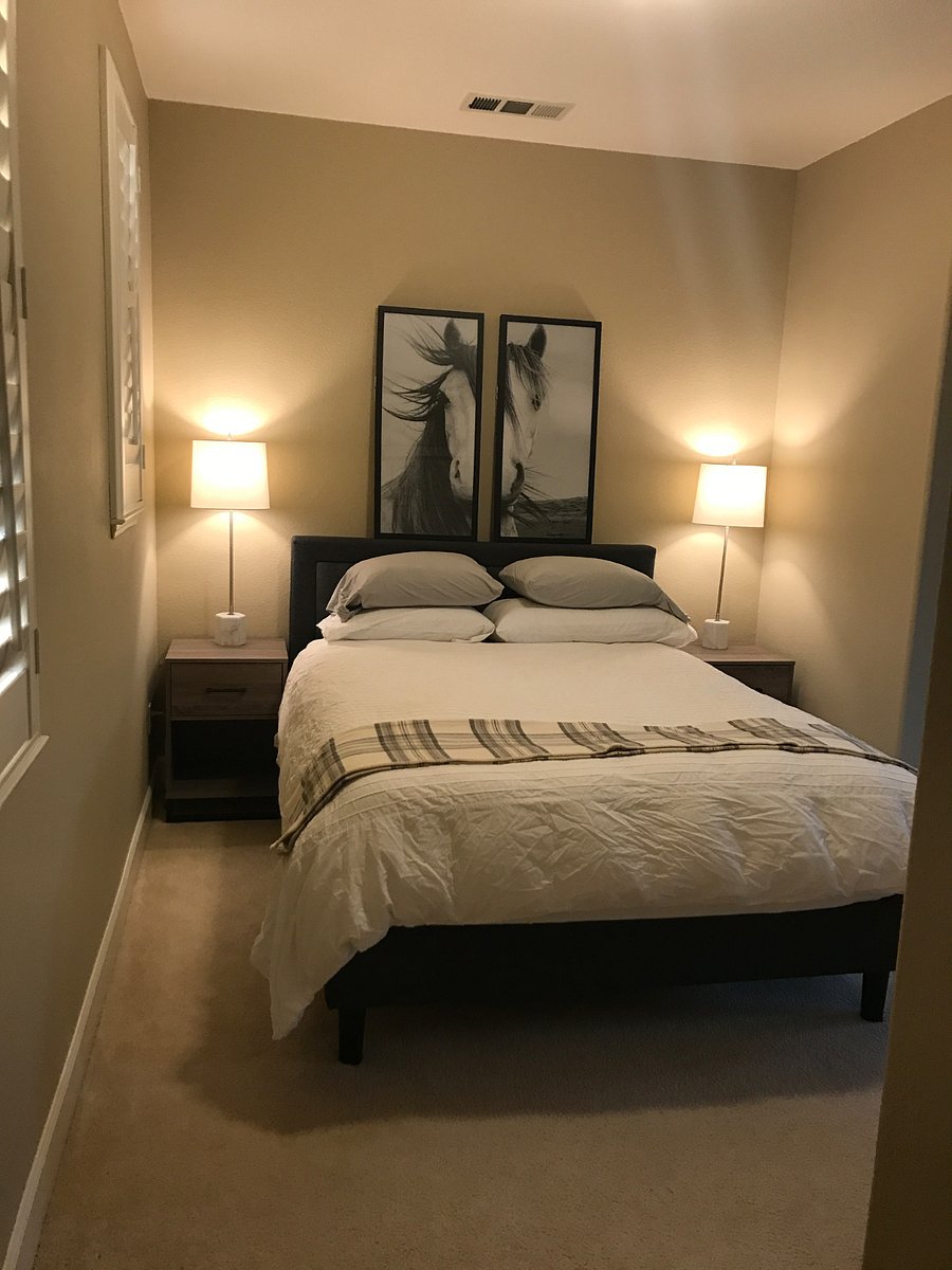 Comfortable queen size bed with nightstands and lamps provide a tranquil sleeping environment.