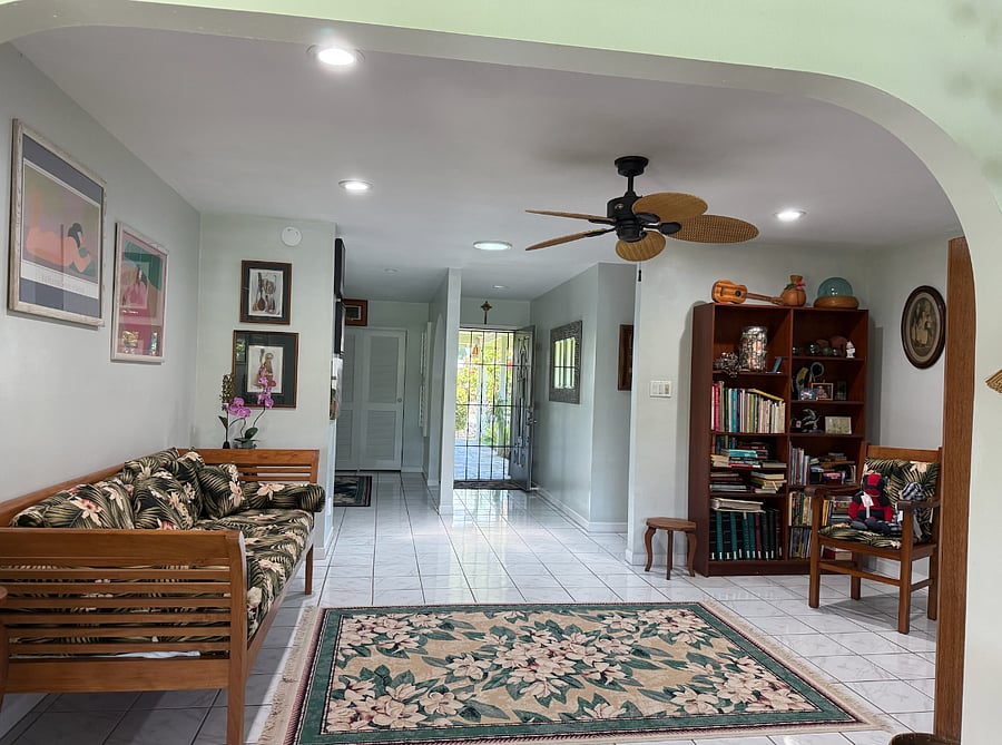An open living room flows between the T.V. room (aka: Family room) and the bedrooms.