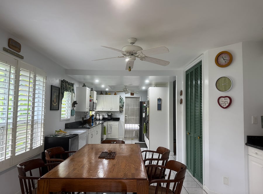 A view of the kitchen from far end of the dining area.
