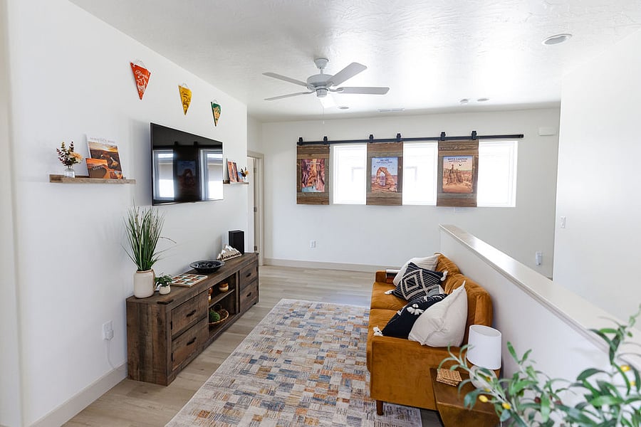 Upstairs loft with couch, smart TV, games, and Xbox. One-of-a-kind barn door window coverings.  