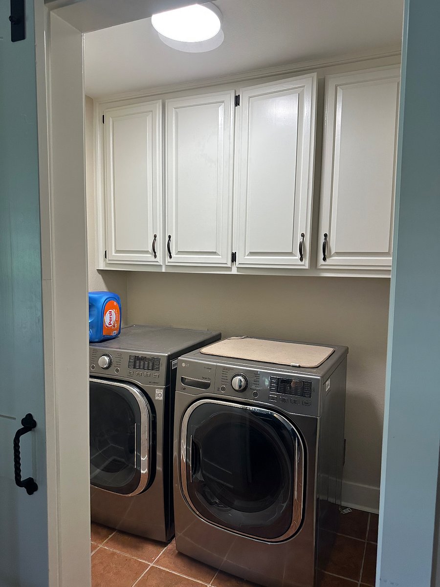 Large capacity, LG washer/dryer. Laundry room off kitchen separated with stylish barn door.