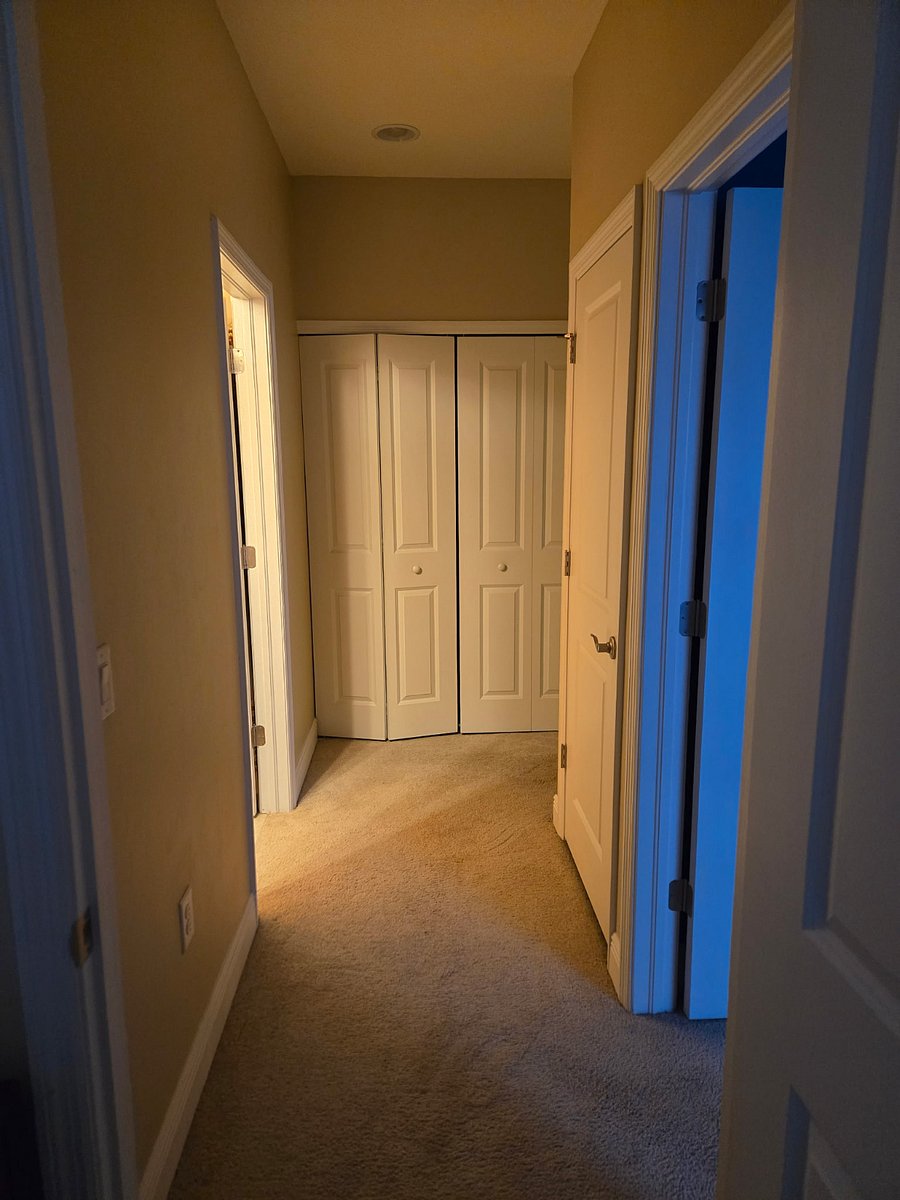 Hallway to the guest bedrooms and guest bathroom. Closet door to the laundry area.