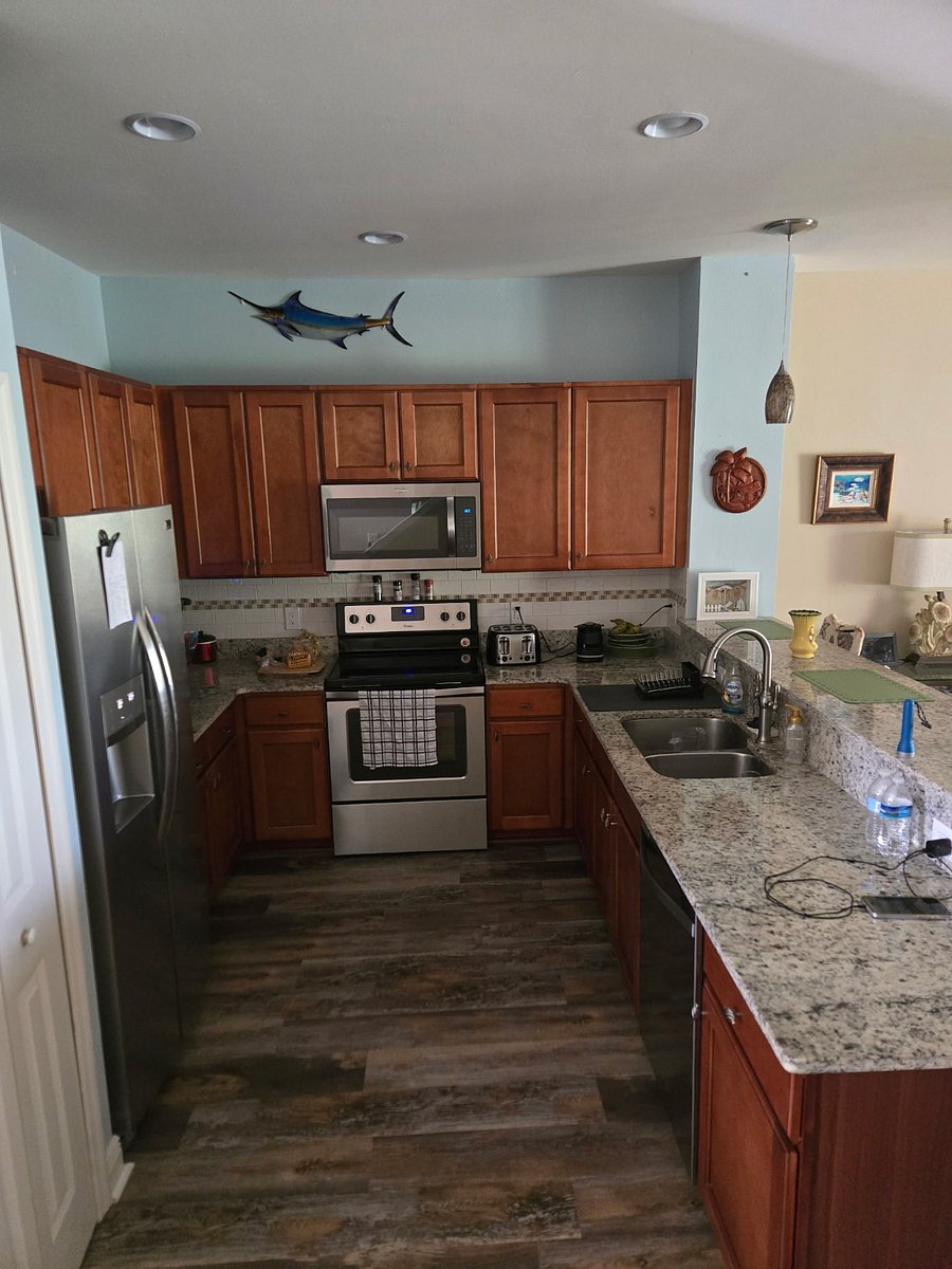 Open kitchen with full size refrigerator, microwave and stove. Tons of cabinet storage. Bar seating for 3 people.