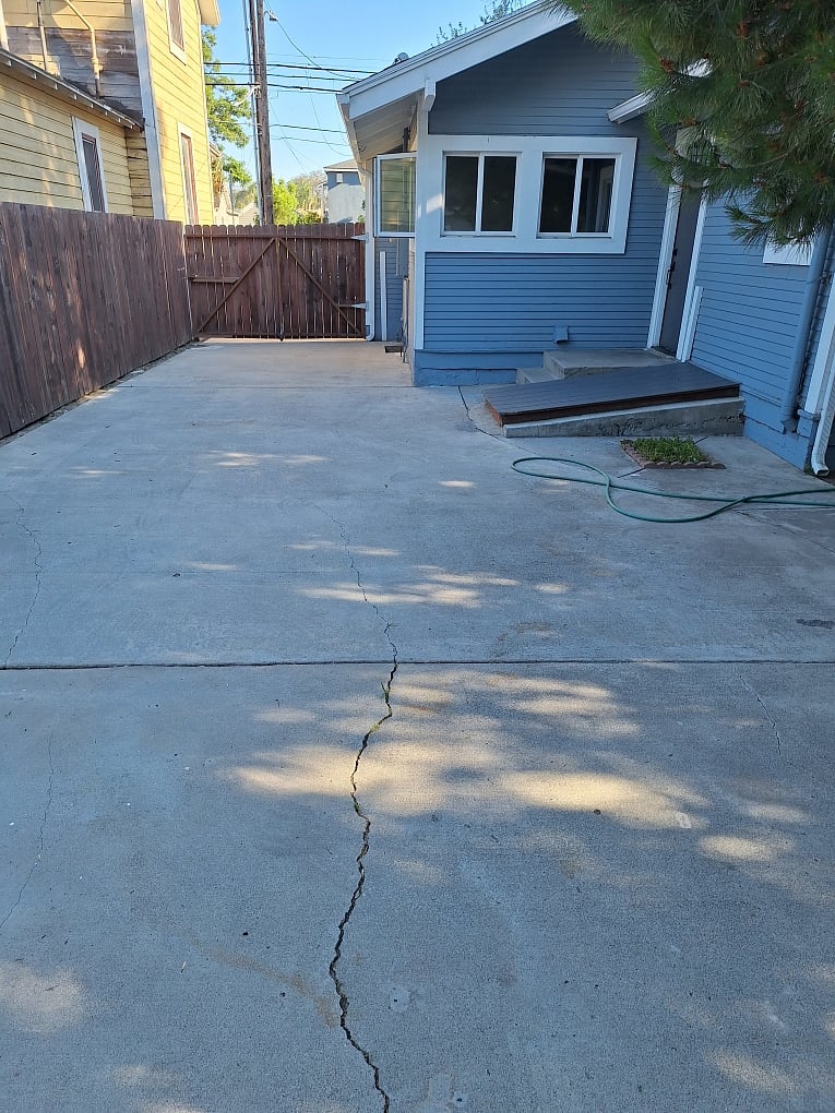 View from detached garage to rear of house with back door