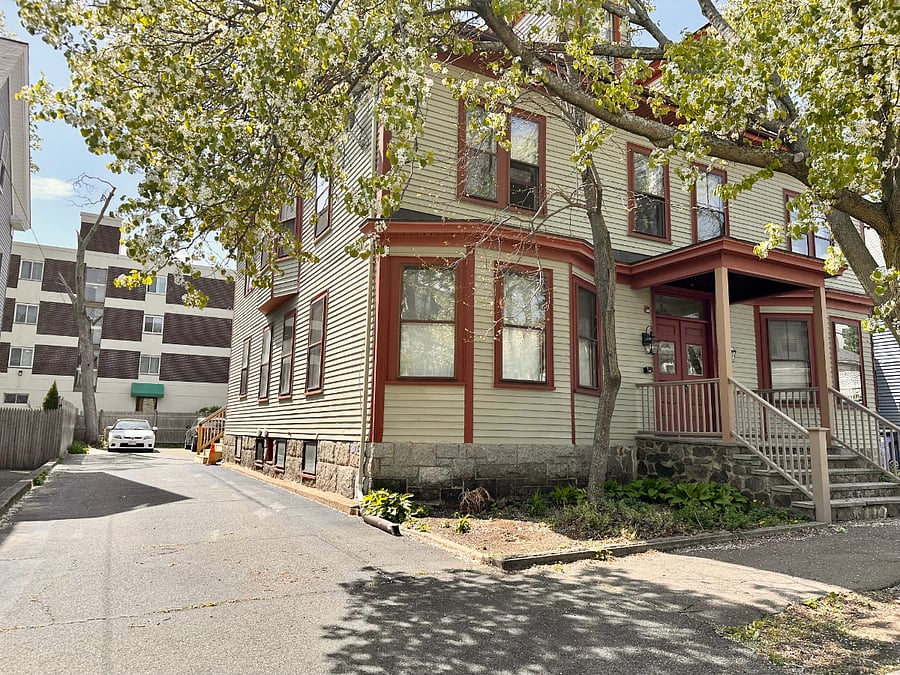 Driveway to private parking lot on left side of building
