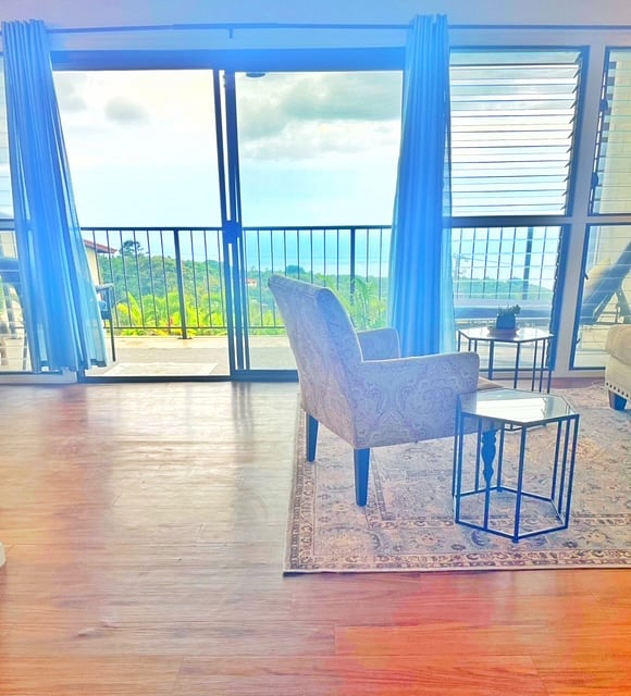 Clean, airy open space facing the ocean breezes. Large sliding doors and louver windows all along the front wall.