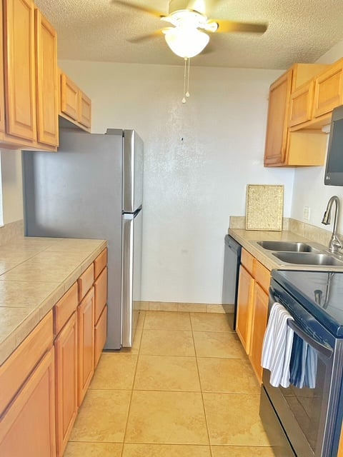 Galley kitchen, full sized refrigerator, microwave, dishwasher. Plenty of dishes and cookware included.