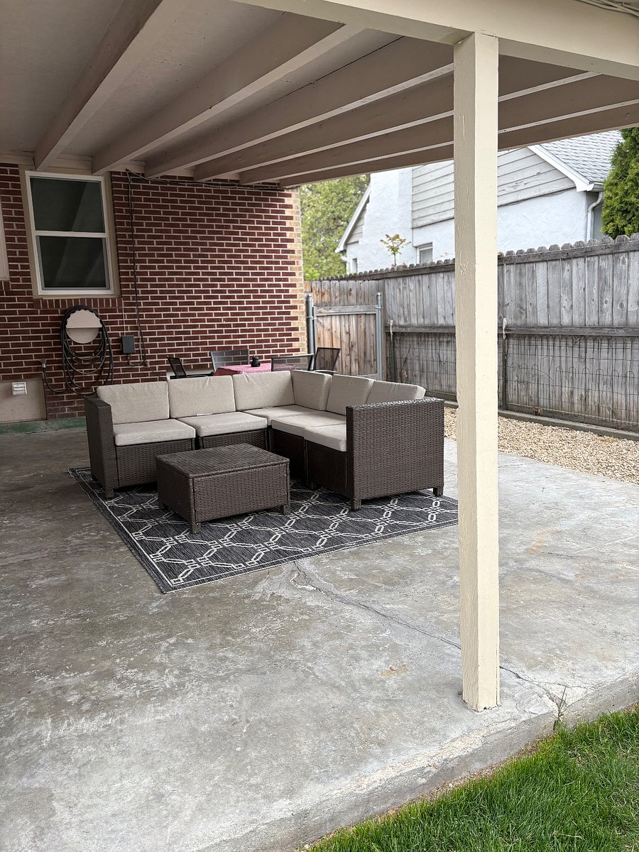 Shared patio space in the backyard. Complete with outdoor sectional and dining table.