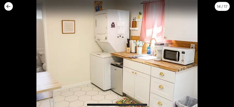 Kitchenette with mini fridge, microwave, Keurig, hot plate, washer and dryer.
