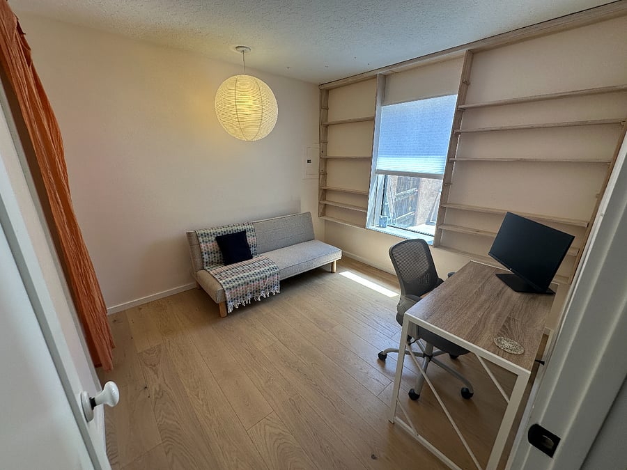 Third bedroom set up as office with futon that unfolds to twin-size bed