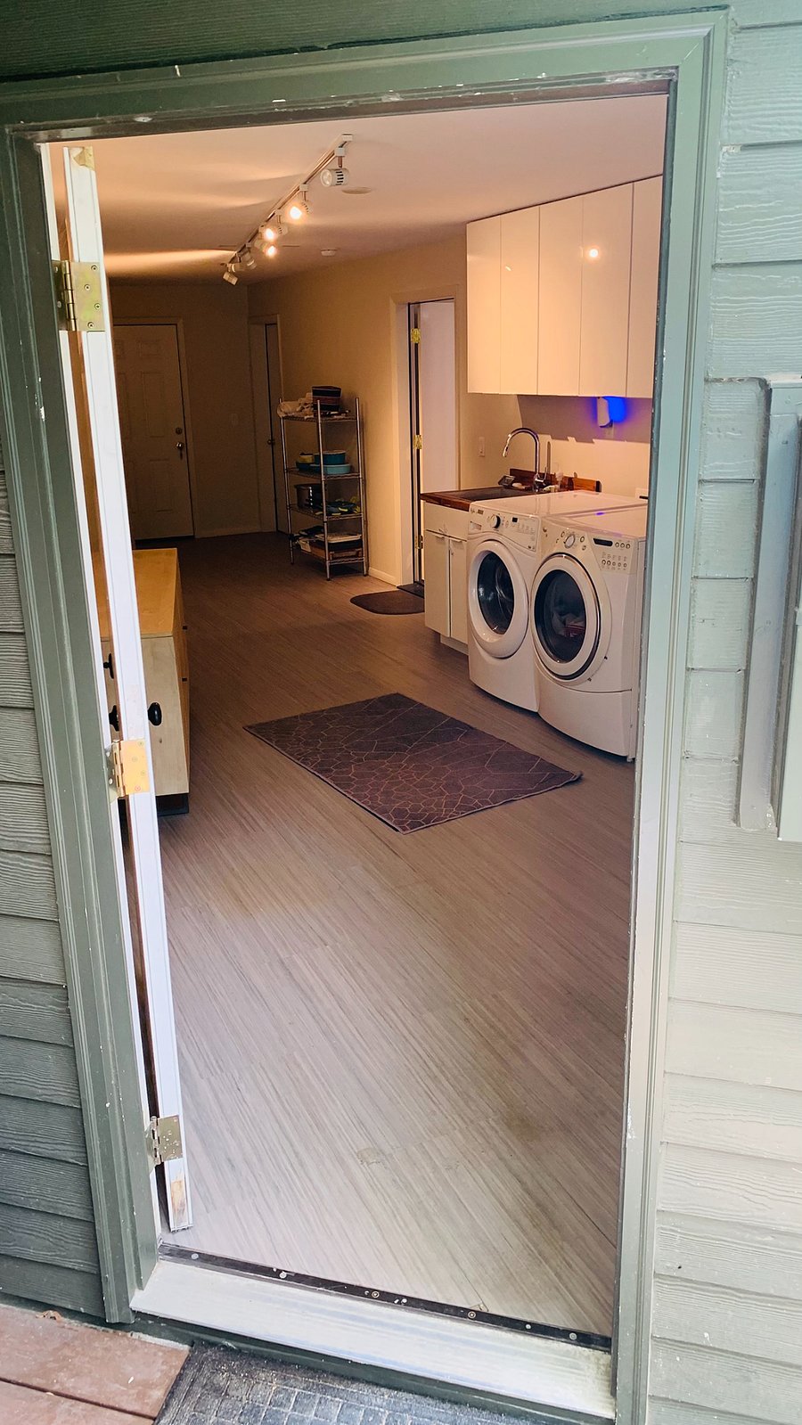 You've arrived! Your laundry room with full sized washer/dryer, and stainless steel sink.   Cabinets and plenty of room for your extra 'stuff'.  A few more steps and...