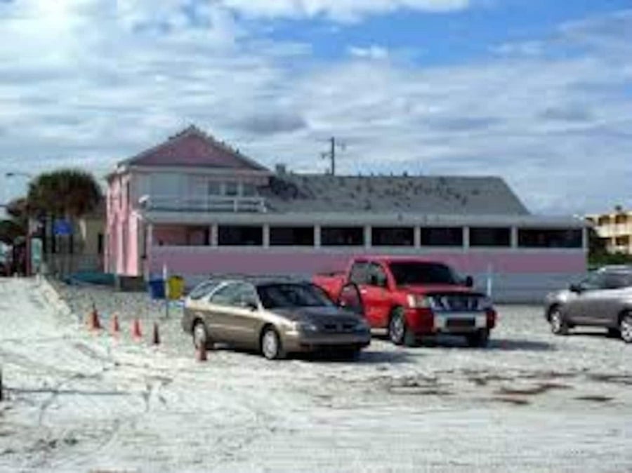 Cars parked on the beach near the Breakers