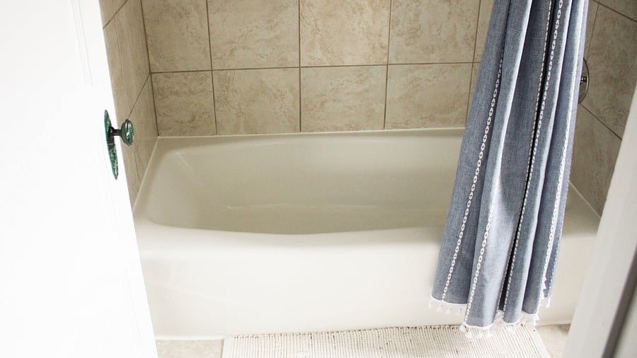 A fresh shower curtain and a large soaking tub greet you when you first enter into your semi-private bathroom. 