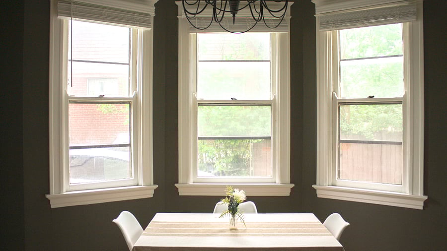 The floor to ceiling bay windows in the kitchen offer a peak at the lush trees just outside. 