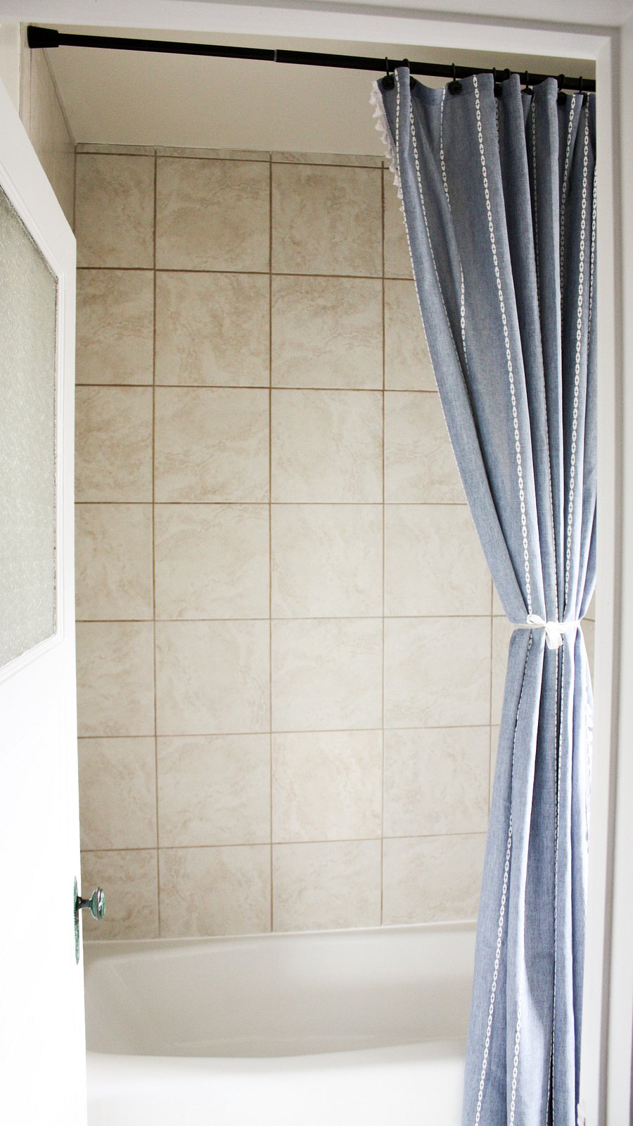 A fresh shower curtain and a large soaking tub greet you when you first enter into your semi-private bathroom.