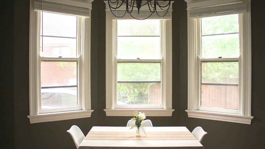 The floor to ceiling bay windows in the kitchen offer a peak at the lush trees just outside.