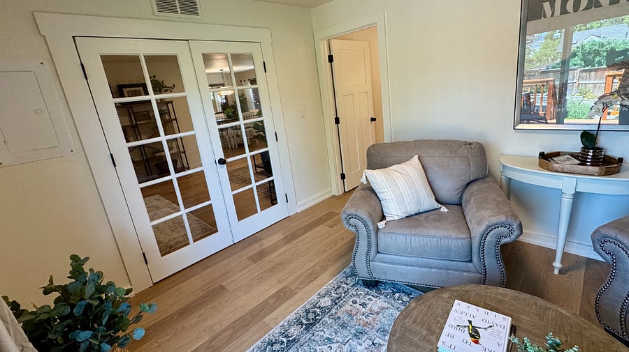 French doors separate the living room from the sunroom and 3rd bedroom.