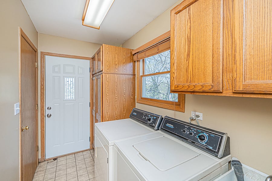 The door in photo is exterior door shared between both suites/apartments. Laundry is shared as well. Door to left has been replaced and is the entrance to the basement unit. Laundry is old but it's better than our new laundry on the other side. We love this washer and dryer, gets the job done better, faster and for less! :) Will not be replacing these any time soon.