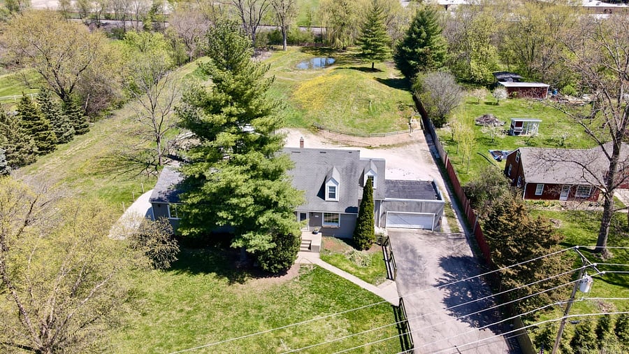 Ariel view of home showing the full fencing and division line of neighbors. 2.5 acres.