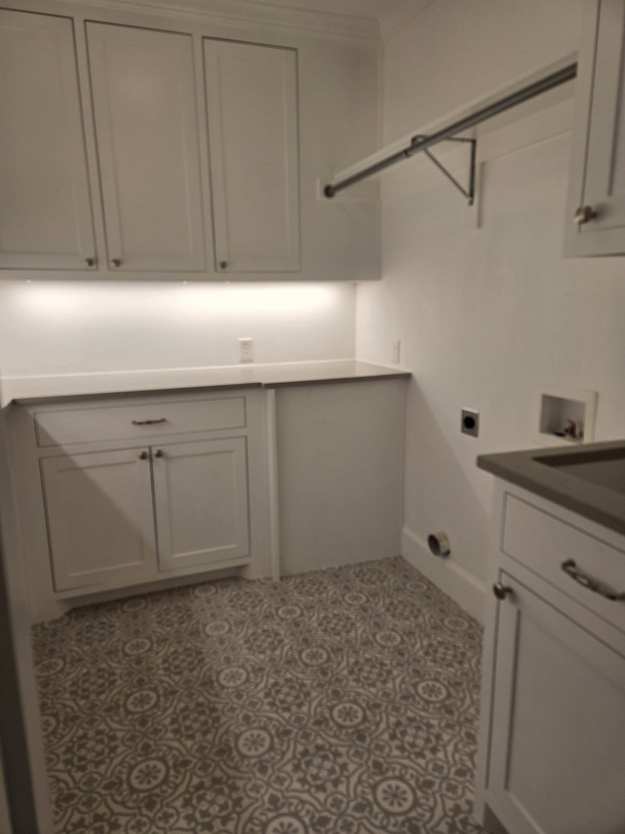 Large laundry/utility room with Washer/Dryer, sink and plenty of cabinets for storage.
