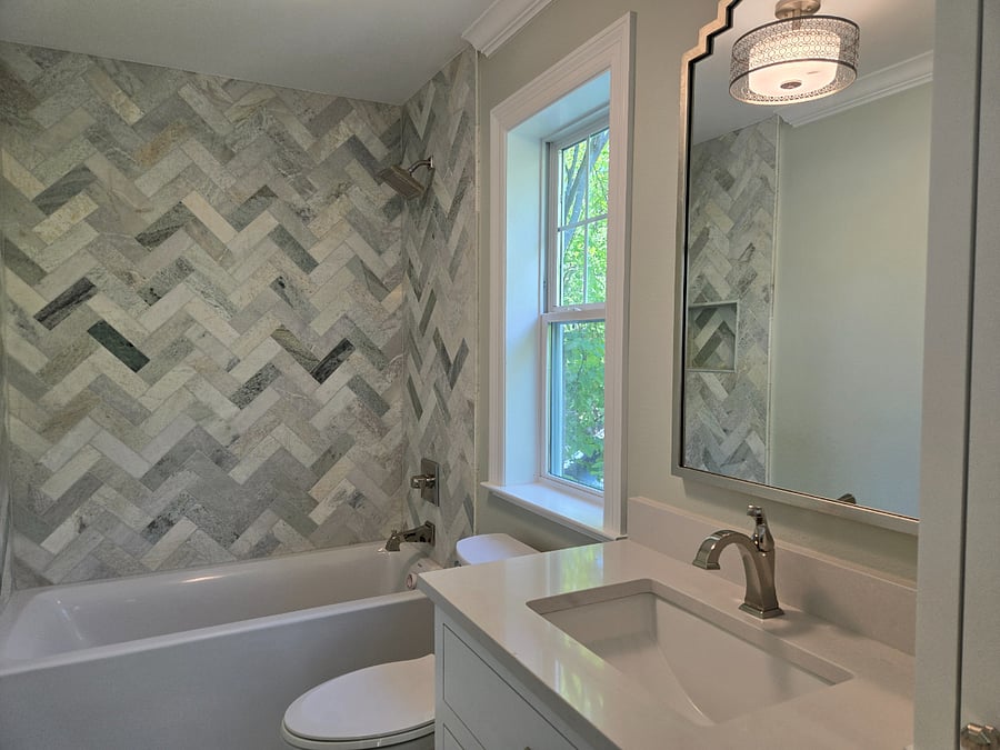 "Serenity Suite" Bath with built in linen cabinet. Marble tile. 