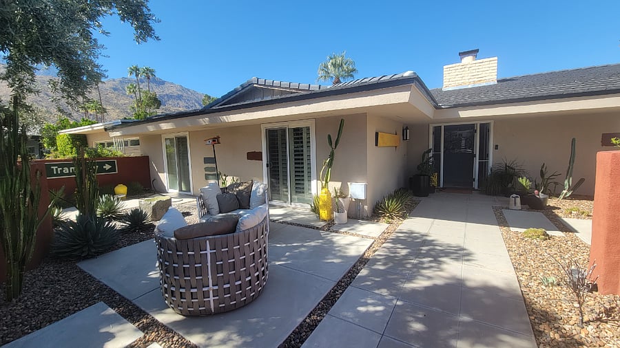 Front patio with fountain, multiple seating places and dining room table