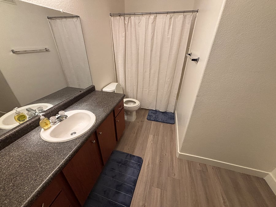 Hall bathroom with tub and shower.  Jack and Jill entrance to bedroom 2.
