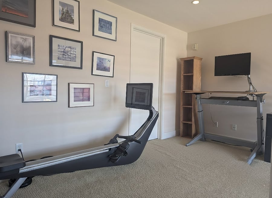 Work area with standing desk and rowing machine