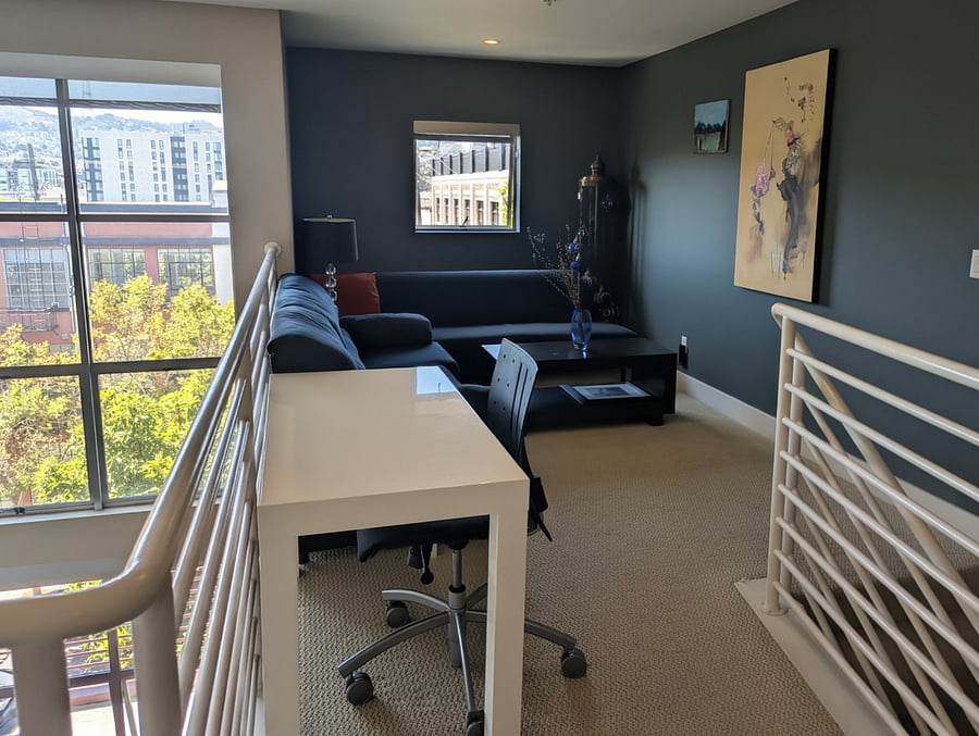 Upstairs reading nook with regular desk for working.