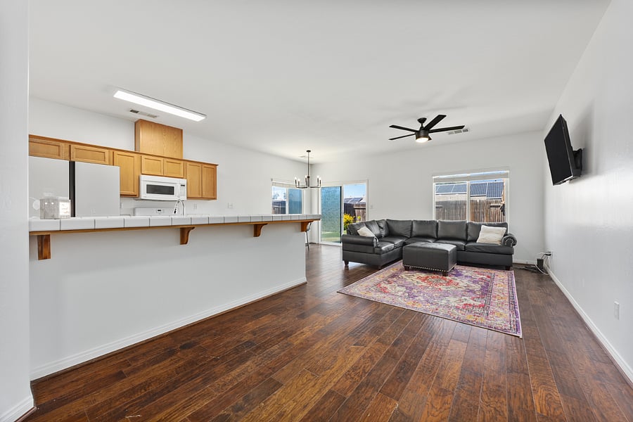 Natural light pours in from large windows and glass slider