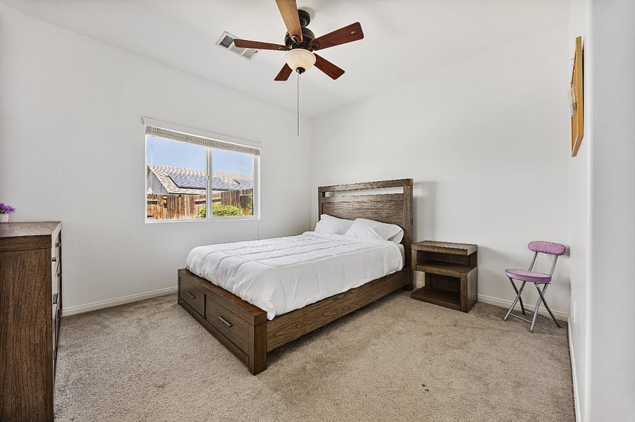 Primary bedroom with attached private bathroom, blackout curtains and spacious layout