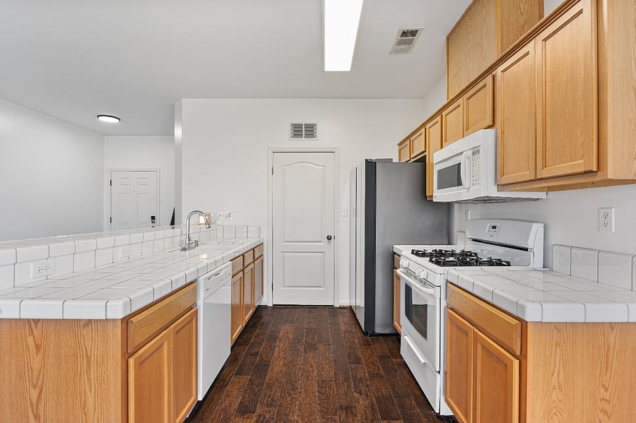 Functional kitchen with stove, microwave and spacious counters