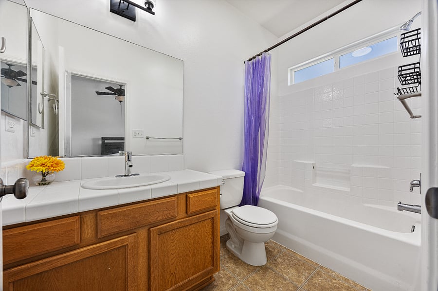 Clean bathroom with full vanity and fresh towels provided 