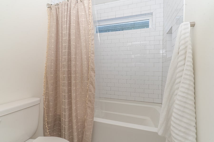 Full bathroom shared by the upstairs queen bedroom and office. Includes double sinks and separate tub and toilet