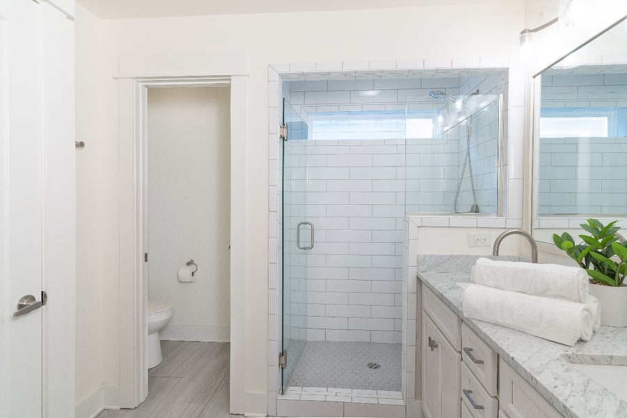 En-suite bathroom for the primary bedroom. Includes double sinks, walk-in shower, closet, and separate toilet closet