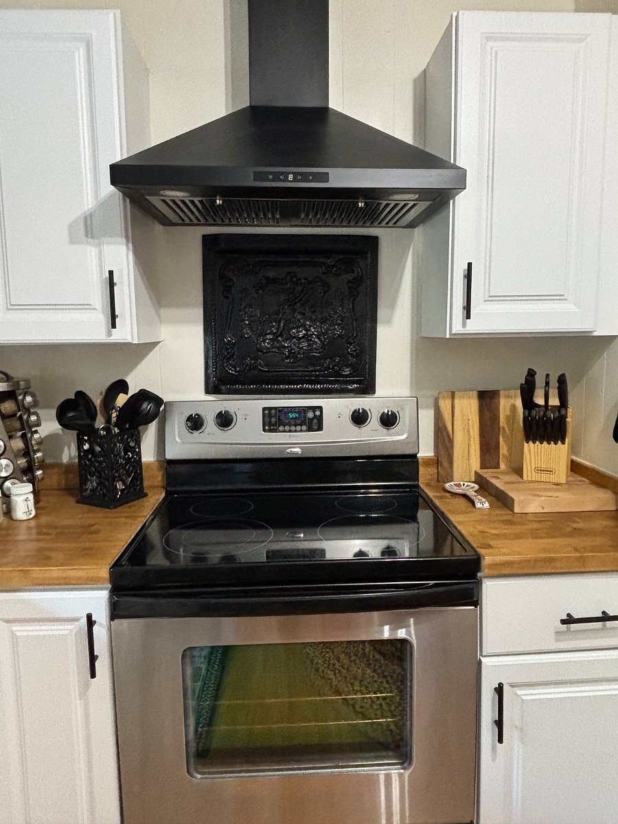 Glass stovetop oven with hood perfect for making meals at home.