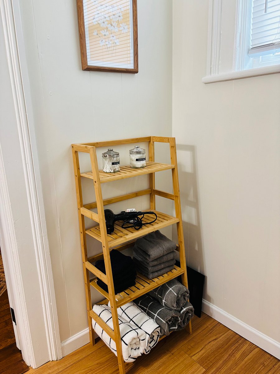 Bathroom storage and includes all linens and has bright natural light with a blind for privacy.