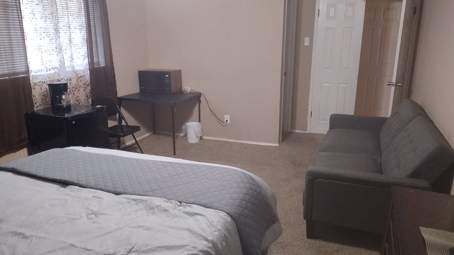 The master bedroom has everything. Queen bed, sleeper couch, A full private bathroom, TV, refrigerator, coffee maker, large microwave, small table and a walk-in closet.