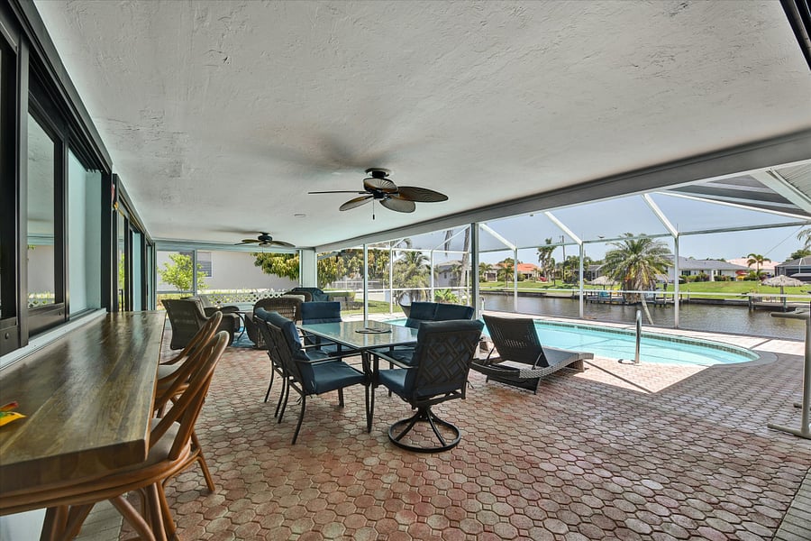 Pass-through window to kitchen with bar and barstools