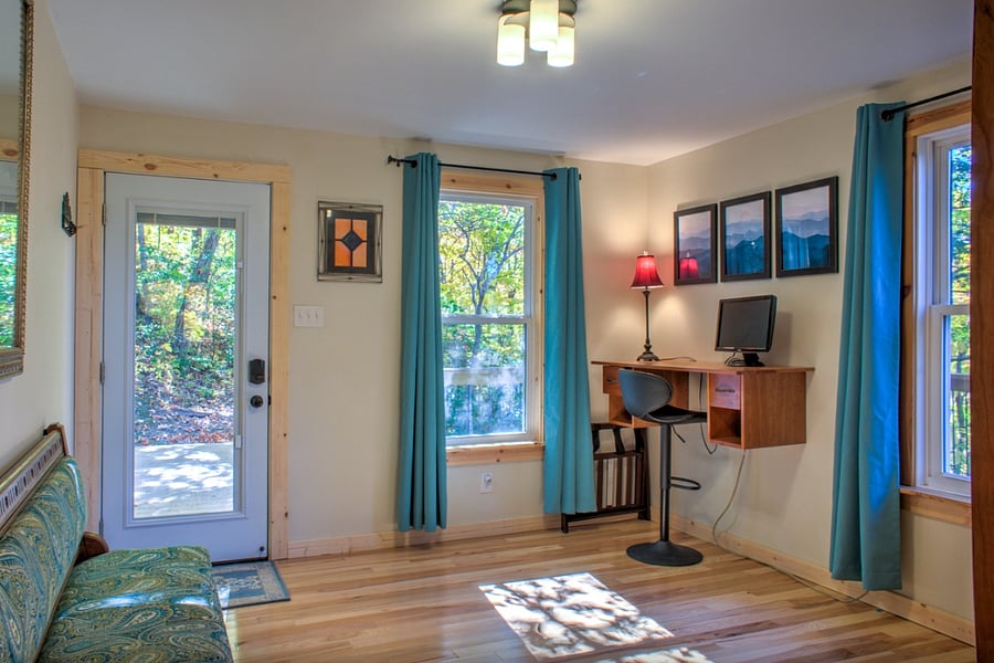 Entry room / office / bedroom with standing desk workstation.