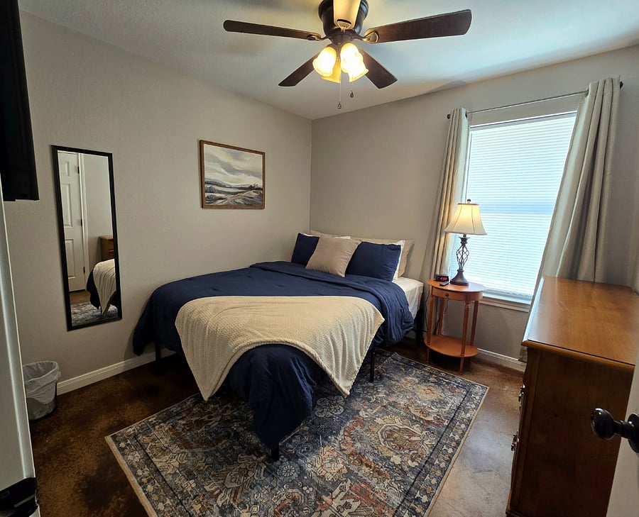Come find calming comfort in the third bedroom. This room includes room darkening curtains, a TV, soft sheets, and plush pillows.
