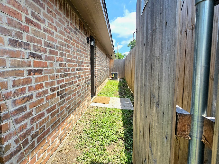 This charming side yard is comfortable for pets and kids.